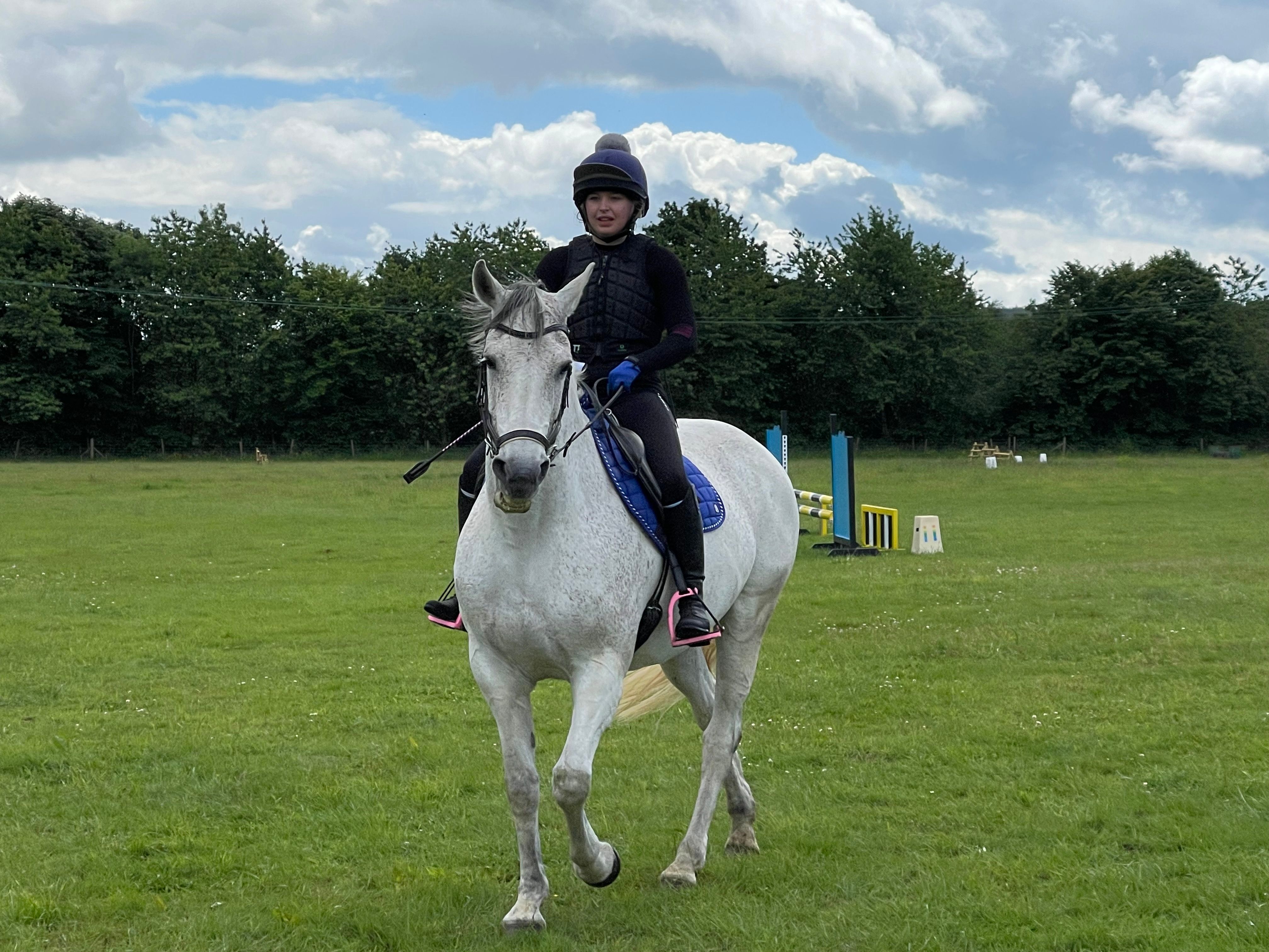 A young rider and pony clearing a jump